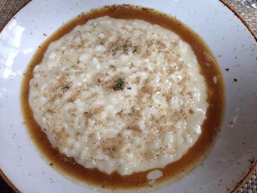 Risotto con polvere di porcini e sugo d' arrosto